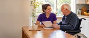 Support worker reviewing an NDIS plan with a participant at home in Hobart